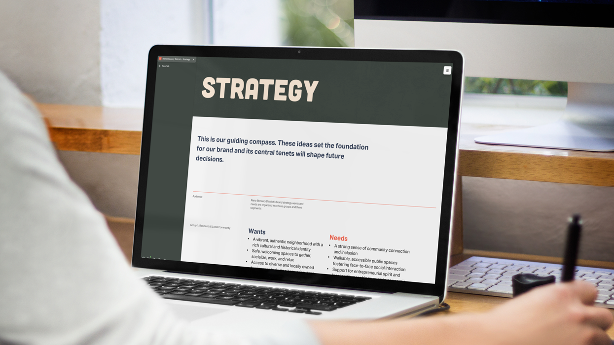 person reading brand strategy on a laptop
